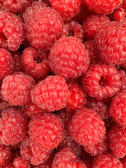 Bright juicy summer background from raspberries close-up