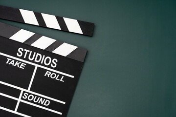 movie clapper on green table background ; film, cinema and video photography concept
