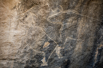 Fototapeta na wymiar Aincent patterns on rocks in National Historic Museum at Gobustan Azerbaijan