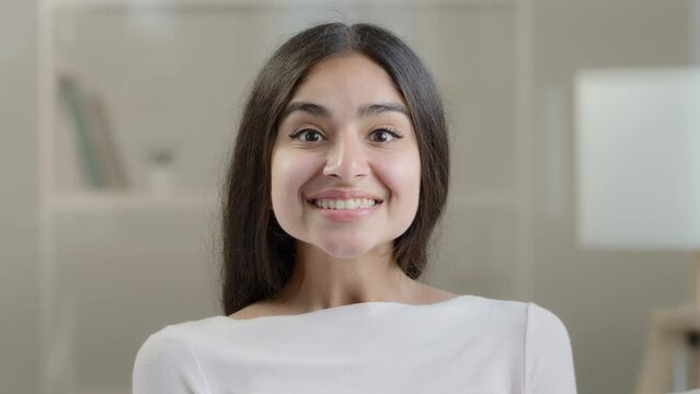 Emotional surprised female face arabic 20s young girlfriend millennial pretty ethnic woman student freelancer demonstrate positive wow reaction euphoria feel delight shock enjoyment successful triumph