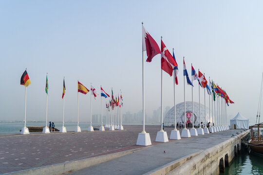 DOHA, QATAR - AUGUST 12, 2022: Flags of the qualified countries for the FIFA World Cup Qatar 2022 at Corniche Doha.