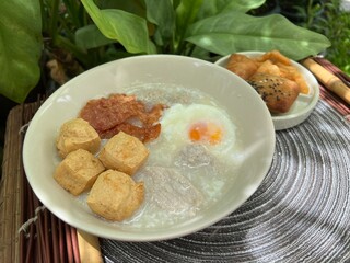 Congee with soft boiled egg and dried pork and fried tofu