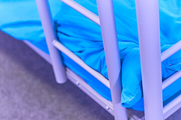 Dorm room bunk bed closeup blue sheets