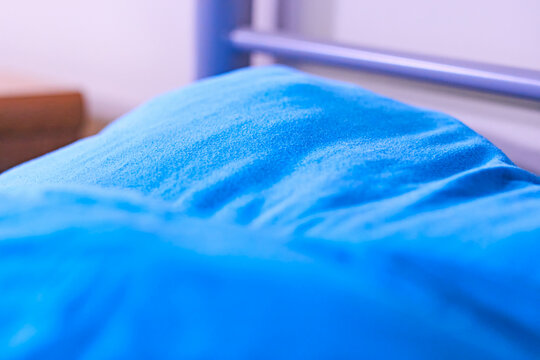 Dorm room bunk bed closeup blue sheets