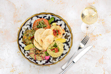 different types of hummus in a plate with pita
