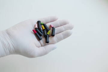 Tubes with teeth composite filling materials in dentist hands