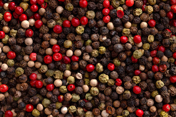 Different colored peppercorns, close up.