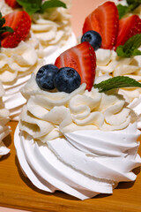 Gourmet pavlova cake with fresh berry topping.
