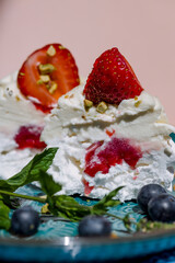 Gourmet pavlova cake with fresh berry topping.