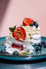 Gourmet pavlova cake with fresh berry topping.