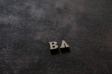 The letters B and A above the dark field. Initials BA