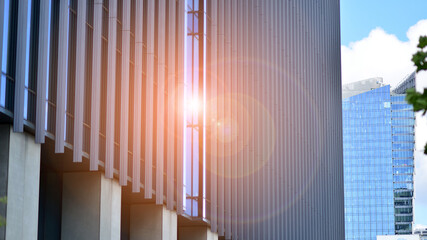  Modern glass facade against blue sky. Bottom view of a  building in the business district. Low angle view of the glass facade of an office building.