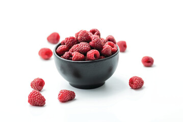 Ripe sweet raspberries in bowl on white background