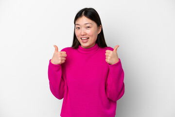 Young Chinese woman isolated on white background giving a thumbs up gesture
