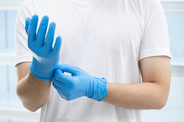 Doctor wearing blue nitrile gloves (select focus)