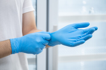 Doctor wearing blue nitrile gloves (select focus)