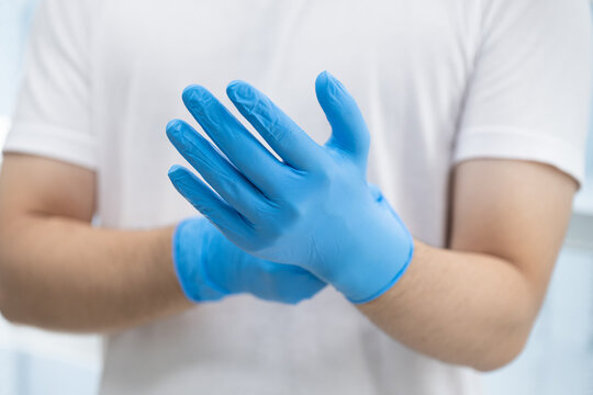 Doctor wearing blue nitrile gloves (select focus)