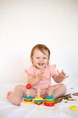  Emotional cute Baby is playing. Infant learning and development. Wooden eco-friendly educational toys. Montessori system.
