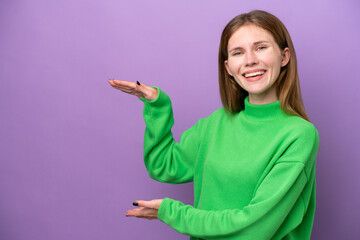 Young English woman isolated on purple background holding copyspace to insert an ad