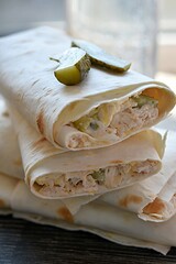 Lavash roll stuffed with cheese, pickles and chicken. Snack. vertical photo
