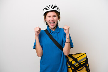 Young English woman with thermal backpack isolated on white background celebrating a victory in winner position