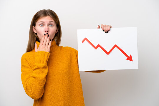 Young English woman isolated on white background holding a sign with a decreasing statistics arrow symbol with surprised expression