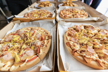 Group of male and female colleagues having pizza lunch together at the office after work celebration concept