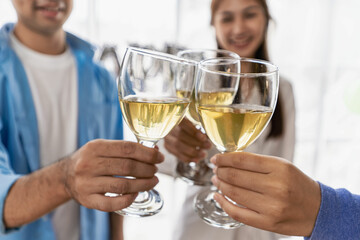 Young Asian male and female colleagues having lunch in the office eating pizza and communicating. The crew of young colleagues are having a pizza party together enjoying their free time.