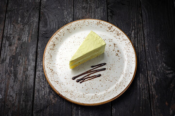 delicious cake with cream on a wooden background