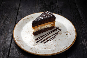 chocolate cake with cream on a wooden background