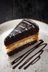 chocolate cake with cream on a wooden background