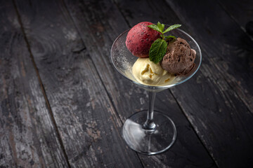 ice cream with chocolate and mint on a wooden background.