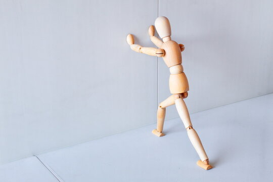 Wooden figure showing a position of stretching muscles to exercise	 - Powered by Adobe