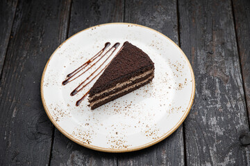 chocolate cake with cream on a wooden background