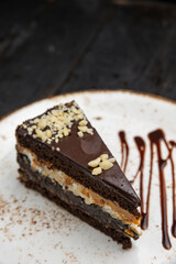 chocolate cake with cream on a wooden background