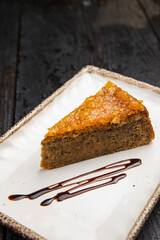 delicious cake with cream on a wooden background