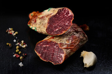 Iberian loin on black slate with peppercorns and garlic