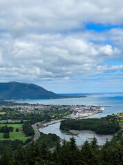 Obraz premium The flagstaff viewpoint area, countryside, Newry, with Warrenpoint town in the distance during the summer. Hiking and Tourism concept