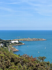 Fototapeta na wymiar View of Dalkey Island from Killiney Hill with sailboats parked up on a sunny day in Ireland