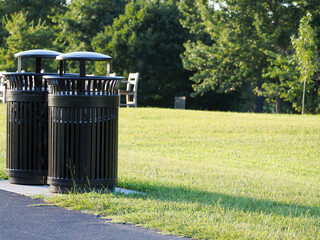 garbage and recycle bins in the park