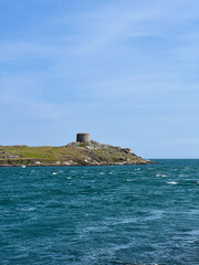 Dalkey Island has a church ruin and a martello tower in the distance, Ireland.