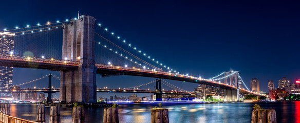 Wide Angle Panorama of the Brooklyn Bridge At Night With Clear Skies
