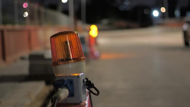 Traffic lights to indicate road construction at night.Panning the camera from left to right