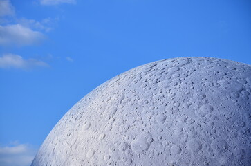 Moon model against blue sky