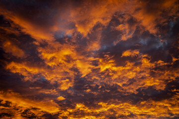 Fototapeta premium Dramatic orange clouds at sunrise or sunset