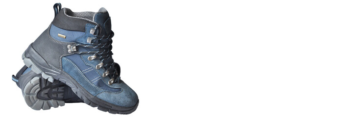 trekking boots on a white background. mountain tourism concept. hiking boots on a light texture....