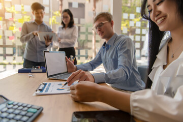 Business meeting, man's hands pointing on charts. Reflection light and flare. Concept image of data gathering and statistical working.