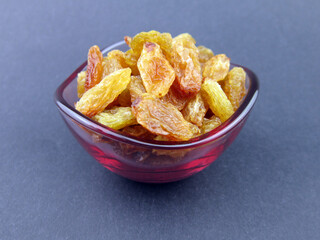      a bowl of yellow golden raisins                 