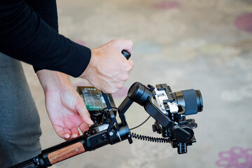 A cinematographer shoots a film on a camera using a camera stabilizer, steadicams for smooth movement of the picture in the frame, a technical device of the film industry.