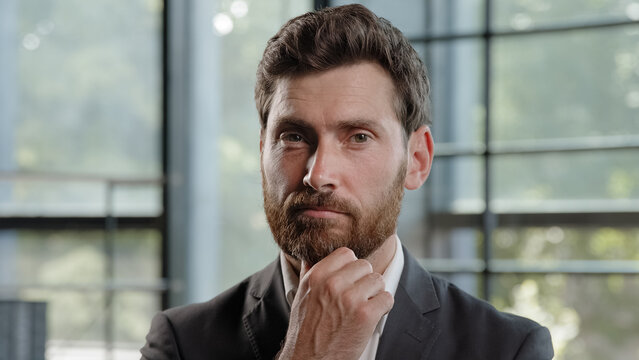 Thoughtful Caucasian bearded 40s businessman thinking solving business problem pensive male professional think in office. Focused CEO boss leader clever puzzled confused man deep in planning thought - Powered by Adobe